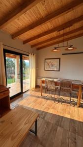 a living room with a wooden table and chairs at Patagonia in Trevelín