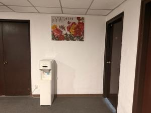a room with a refrigerator and a picture on the wall at Anika Inn Kluang in Kluang