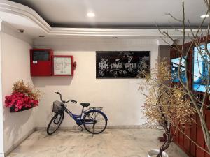 a bike parked against a wall in a room at Anika Inn Kluang in Kluang