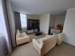 a living room with two couches and a flat screen tv at Miski Wasi in Tacna