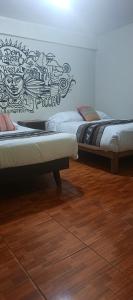 two beds sitting next to each other in a room at AMARU Palace in Machu Picchu