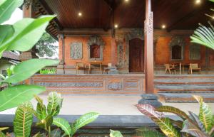 an outside view of a building with tables and chairs at Selau Asry in Sidemen