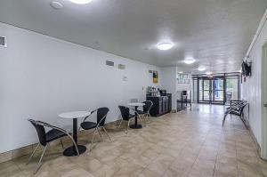 a room with two tables and chairs in it at EXPRESS INN Troy in Troy