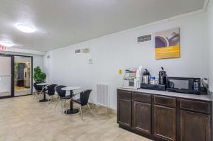 a room with a kitchen with a counter and chairs at EXPRESS INN Troy in Troy