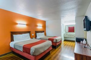a hotel room with two beds and a television at EXPRESS INN Troy in Troy