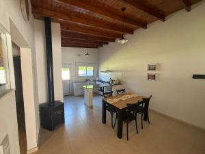 a kitchen and dining room with a table and a stove at Doña Mercedes in Verónica