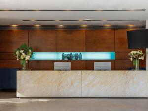 a lobby with a reception desk with flowers on it at Peppers Blue on Blue in Nelly Bay