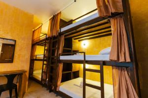 a room with bunk beds in a hostel at The Shack Hideaway by Mayumi Resorts in Mabini