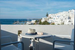 a hat sitting on a table on a balcony at Kanale's Rooms & Suites in Naousa