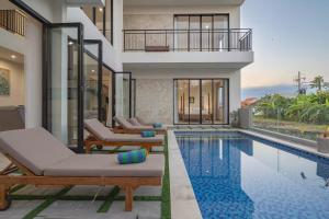 a villa with a swimming pool and a house at Zen Villa - Central Canggu in Canggu