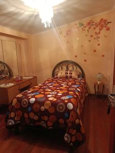 a bedroom with a bed with a teddy bear on it at Casa Magnolia in Cochabamba