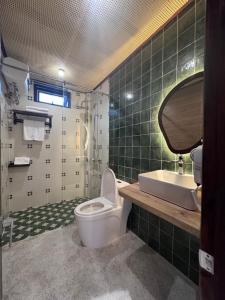 a bathroom with a toilet and a sink at The Hue Verandah in Thôn Trường Giang +4 photos