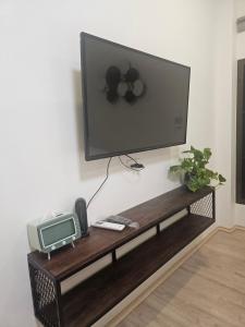 a flat screen tv sitting on top of a tv stand at Khiri&Kiwi homestay in Ban Mae Rim Nua
