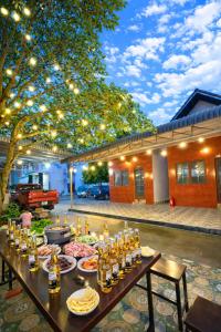 a table full of food and drinks on a patio at Lê Thuận Hotel in Lai Vung
