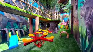 a play room with colorful furniture and a play house at Hotel & Suites Country Valladolid in Valladolid