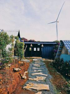 a building with a wind turbine in the background at An House in Xuân Trường
