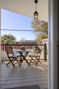a patio with two chairs and a table on a deck at Relaxing Poolside Condo in Savannah