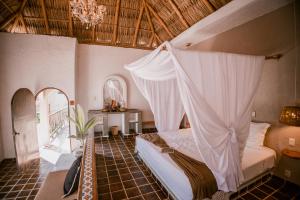 a bedroom with a bed with a mosquito net at baXar in Pie de la Cuesta +95 photos