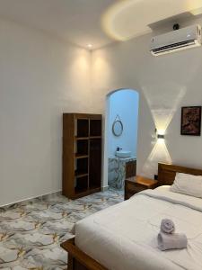 a bedroom with a bed and a sink in it at Mahoney Homestay in Kuta Lombok