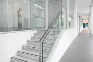 a staircase with glass railings in a building at A Hotel Dickson, Stay From 9PM To 8AM in Singapore