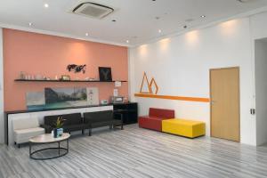 a waiting room with a couch and a table at A Hotel Dickson, Stay From 9PM To 8AM in Singapore