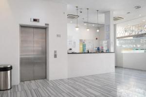 a lobby with a metal door and a counter at A Hotel Dickson, Stay From 9PM To 8AM in Singapore