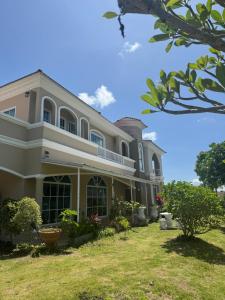 a large house with a yard in front of it at Paiyawadee House khaoyai in Ban Hua Phrong