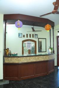 a bar in a restaurant with two lights at Hotel Priso in Kālapettai