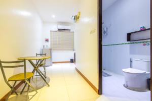 a room with a toilet and a table and a stool at Tongtong Garden Holiday Hotel普吉岛通通花园酒店 in Rawai Beach +113 photos