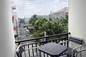 a balcony with a bench and a view of a street at Diponegoro House Solo Baru in Solo +2 photos