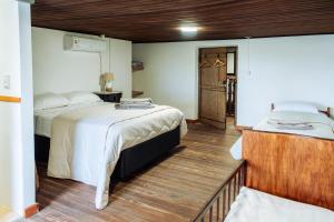 a bedroom with two beds and a hallway with a door at Posada San José de Lucas in Tupambaé +31 photos