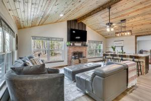 a living room with leather furniture and a fireplace at Fish Sam Rayburn! Secluded Cabin w/ Deck & Grill in Brookeland
