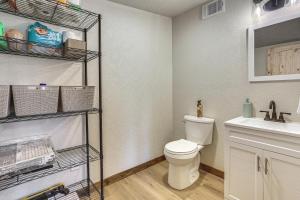 a bathroom with a toilet and a sink at Fish Sam Rayburn! Secluded Cabin w/ Deck & Grill in Brookeland +19 photos