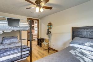 a bedroom with a bunk bed and a ceiling fan at Fish Sam Rayburn! Secluded Cabin w/ Deck & Grill in Brookeland
