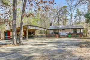 a small house in the middle of a forest at Fish Sam Rayburn! Secluded Cabin w/ Deck & Grill in Brookeland