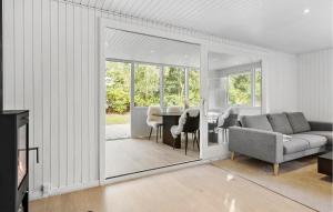 a living room with a couch and a table at Nice Home In Farsø With House A Panoramic View in Farsø