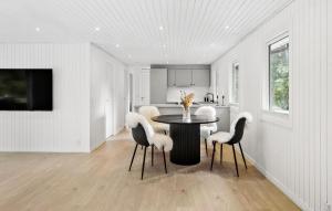 a dining room with a table and chairs at Nice Home In Farsø With House A Panoramic View in Farsø