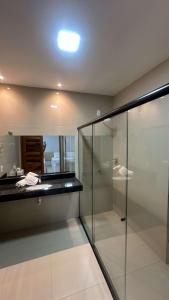 a bathroom with a glass shower and a sink at Oceane Norte Hotel in Parnaíba +54 photos