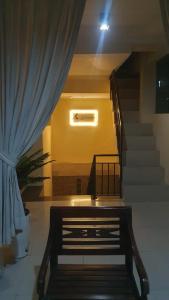 a staircase in a building with a blue curtain at Deva'sya Room Rent Nusa Dua in Nusa Dua
