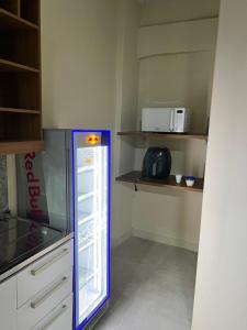 a kitchen with an empty refrigerator in a room at Pousada do Leo in Olinda