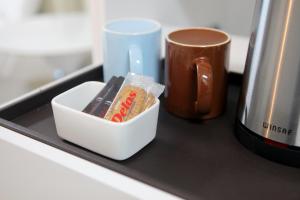 a tray with a container of toothpaste and a cup of coffee at 서프리조트 양양 빅웨이브 in Yangyang