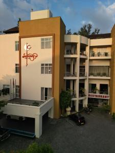 an apartment building with a sign on the side of it at Kethumathee Hotel & Banquet in Ratnapura