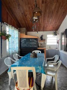a dining room with a blue table and chairs at Picaflor in Barra del Chuy