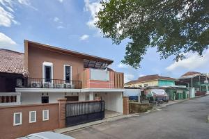 a house on the side of a street at RedDoorz at Lumungga Residence Lampung in Lampung