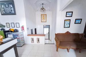 a living room with a couch and a stairway at RedDoorz at Lumungga Residence Lampung in Lampung