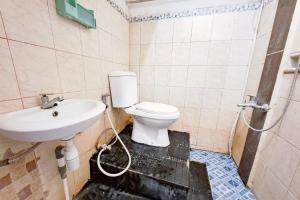 a bathroom with a sink and a toilet at RedDoorz at Lumungga Residence Lampung in Lampung