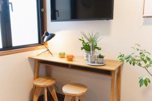a small table with two stools next to a window at Near Ikebukuro, Kitchen & Laundry, Fast Wi-Fi, 4min to Station,Many restaurants nearby!! in Tokyo +18 photos
