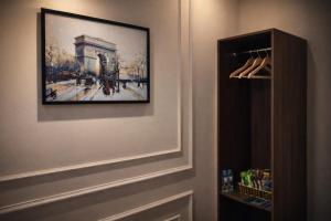 a painting hanging on a wall next to a closet at Vũ Ngọc Hotel Núi Sam in Chau Doc