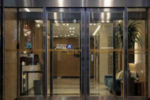 a glass door of a building with a sign on it at Residence Hotel K Okpo in Geoje