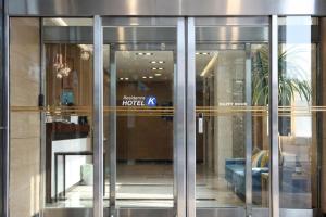 a lobby of a hotel with glass doors at Residence Hotel K Okpo in Geoje